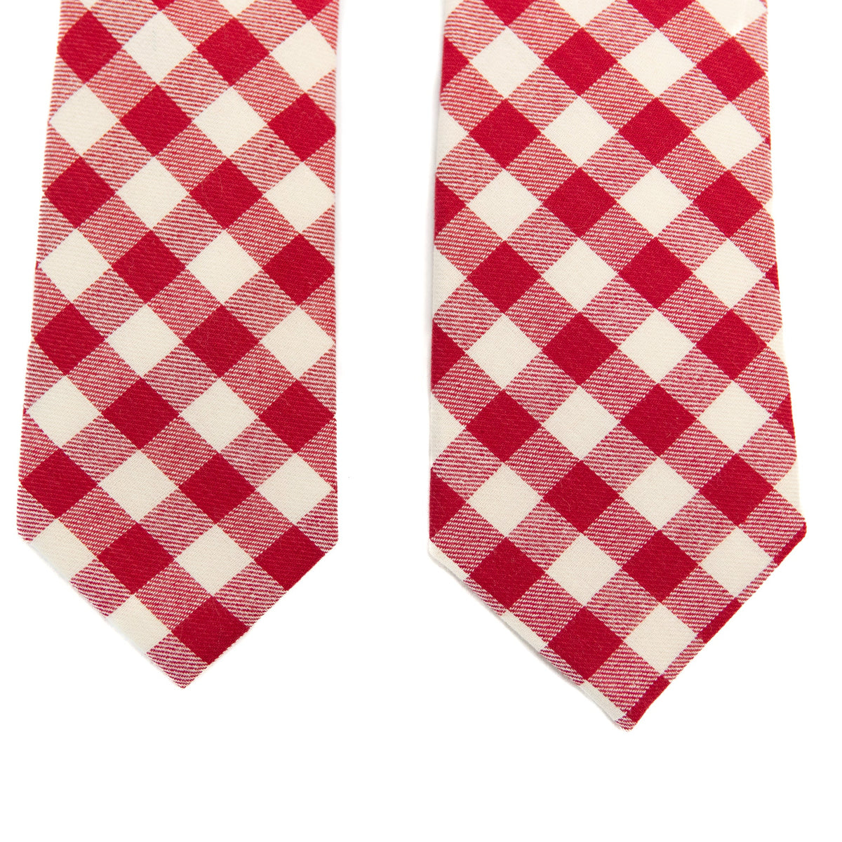 Two men's red-and-cream plaid neckties laid side by side