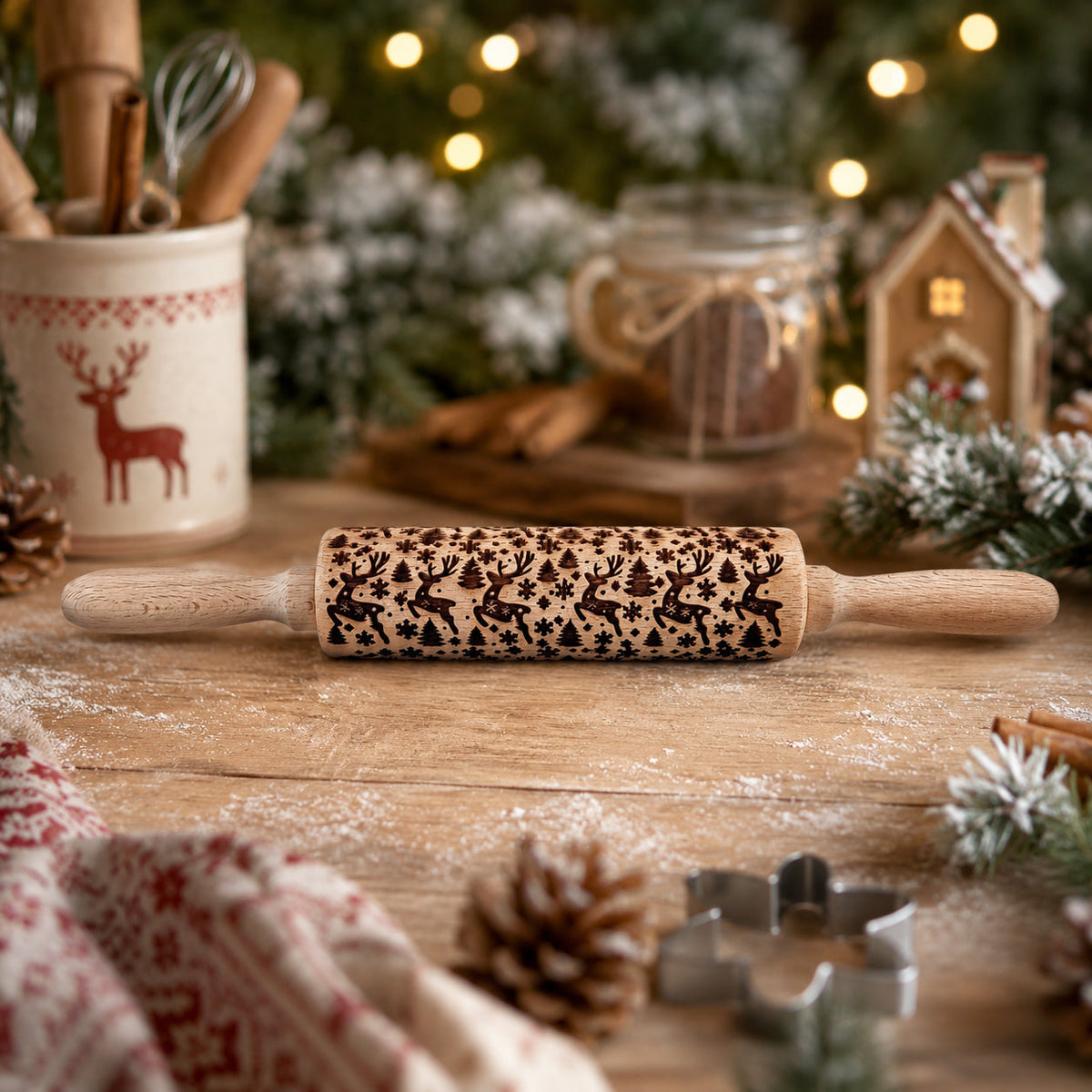 Wooden Christmas rolling pin with dark holiday icon pattern, resting on a dusted wooden table.
