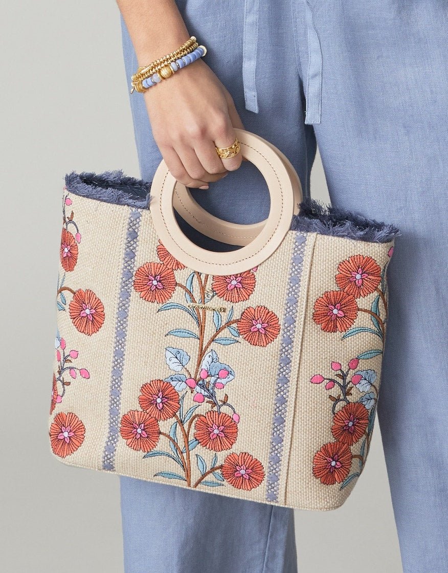 Floral canvas tote with round handle, navy frayed trim, and open top lining