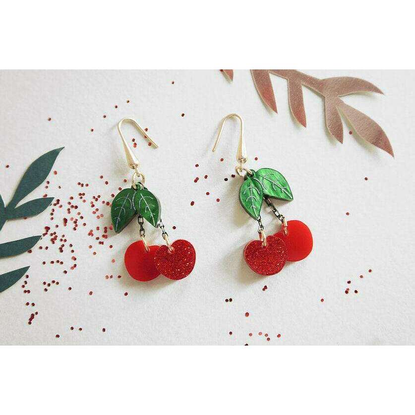 Cherry statement earrings featuring green leaf charms and red double-cherry drops