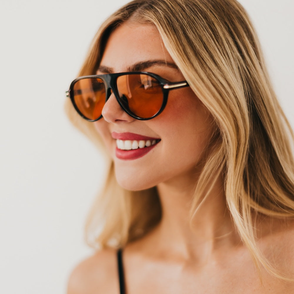 Oval sunglasses with tortoise frame and amber-tinted lenses