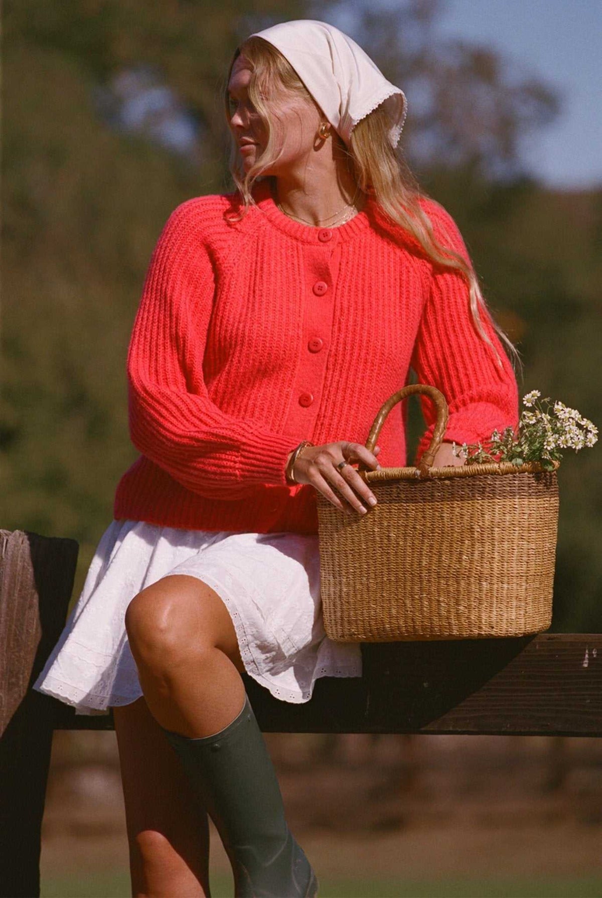 Bright red button-front knit cardigan sweater with textured knit and long sleeves.
