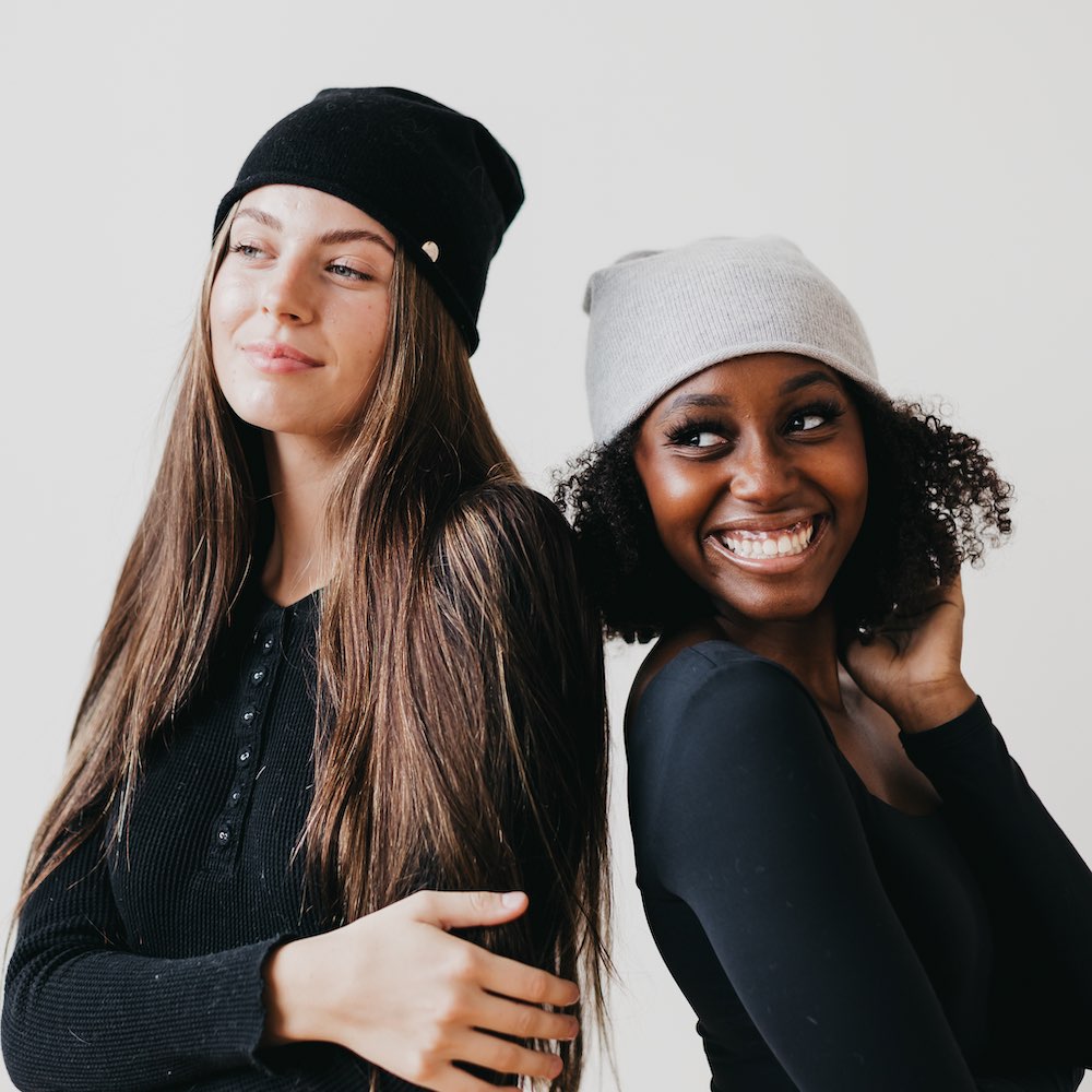 Black and light gray rolled-edge cashmere beanies shown worn