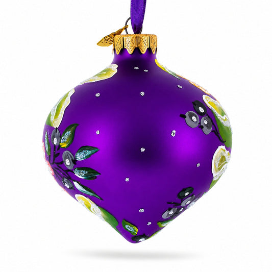 Purple glass onion ornament with green leaves, bird icons, and gold hanging cap