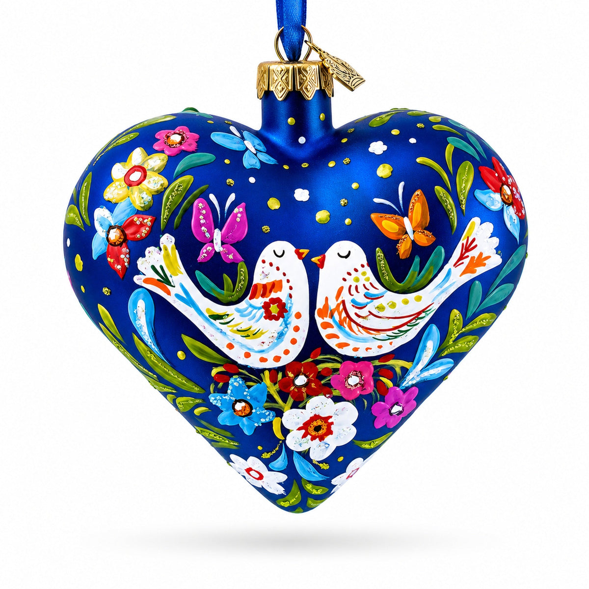 Heart-shaped blue glass ornament with whimsical white doves, flowers, and hanging blue ribbon