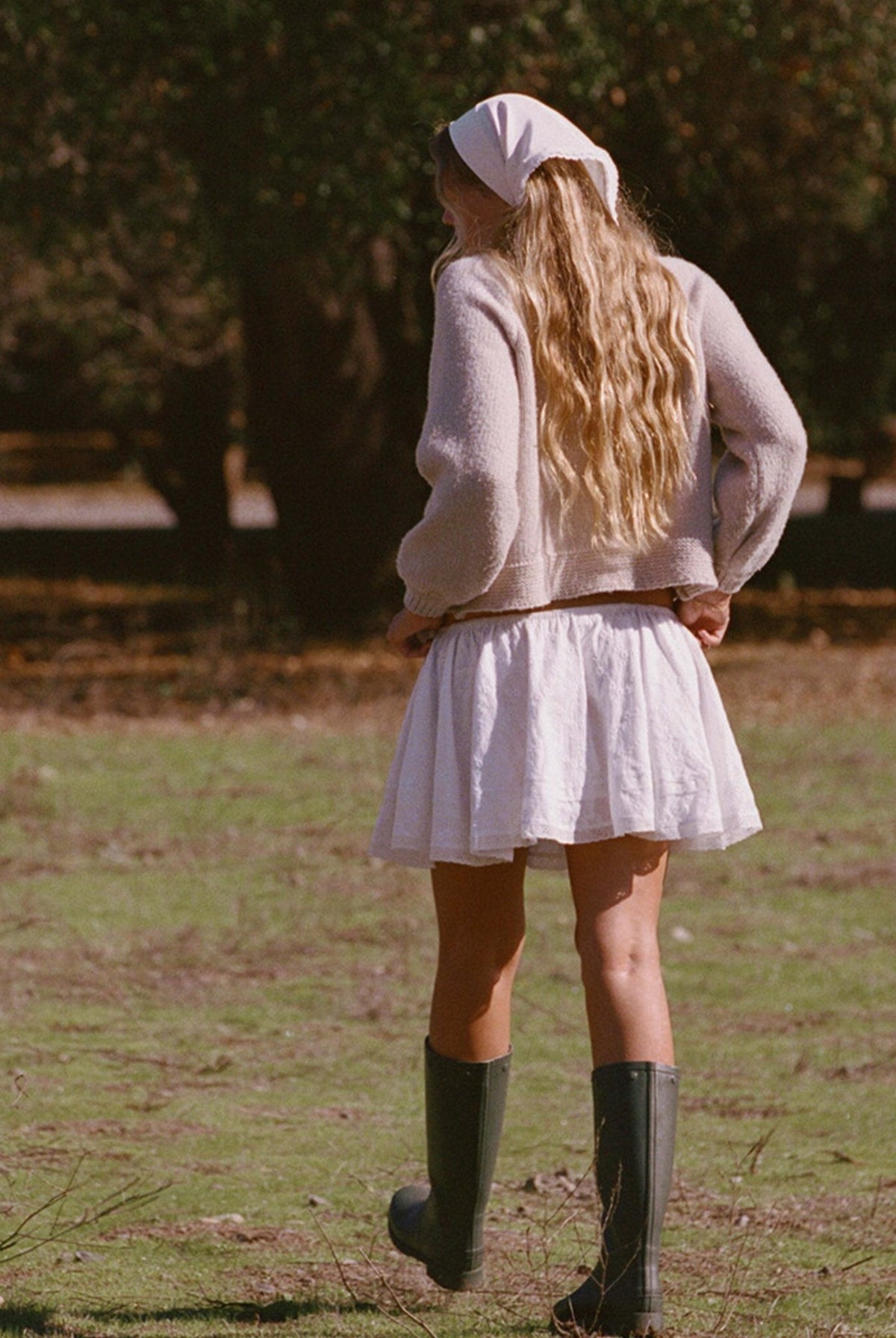 Oatmeal knit cardigan sweater with long sleeves and button detail, back view