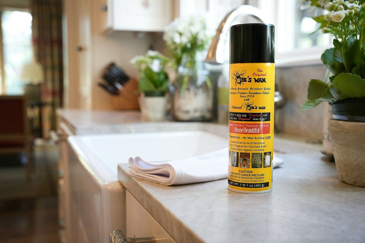 Bee's wax furniture polish bottle with black cap on kitchen counter