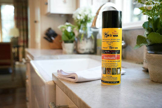 Bee's wax furniture polish bottle with black cap on kitchen counter