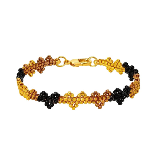 Beaded bracelet with gold, black, and brown heart pattern, gold clasp and ring