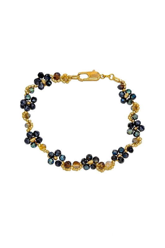 Gold-tone handmade beaded bracelet with iridescent floral accents and blue-black beads