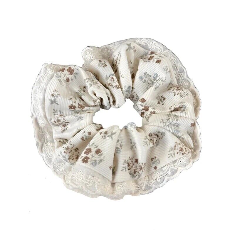 Floral velvet hair scrunchie in cream with brown and light blue accents, ruffled edge