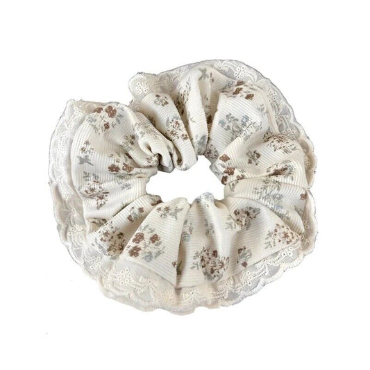 Floral velvet hair scrunchie in cream with brown and light blue accents, ruffled edge