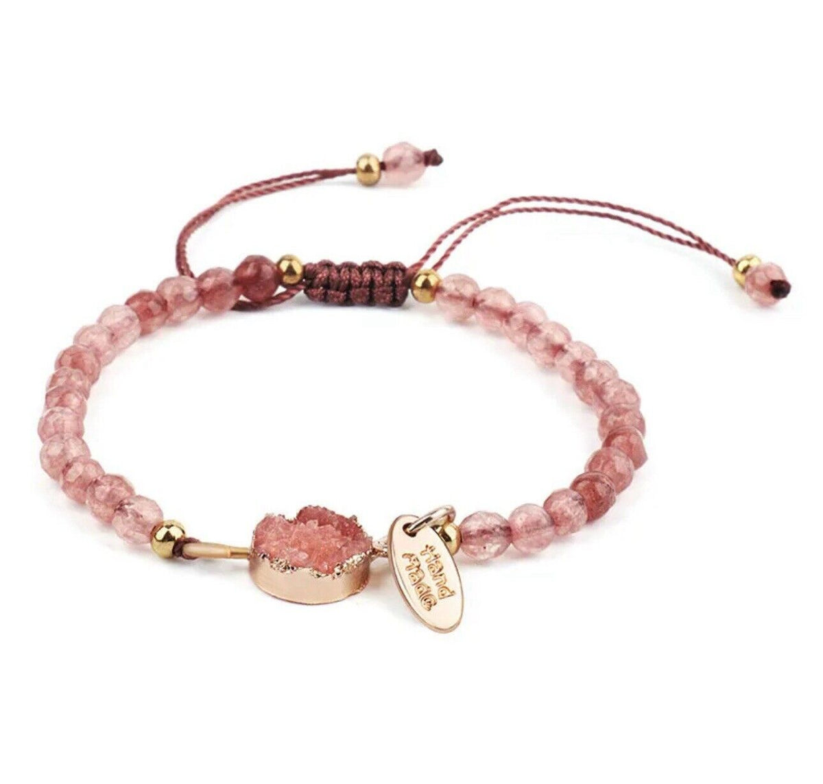 Pink beaded braided strand bracelet with gold charms and adjustable tie ends