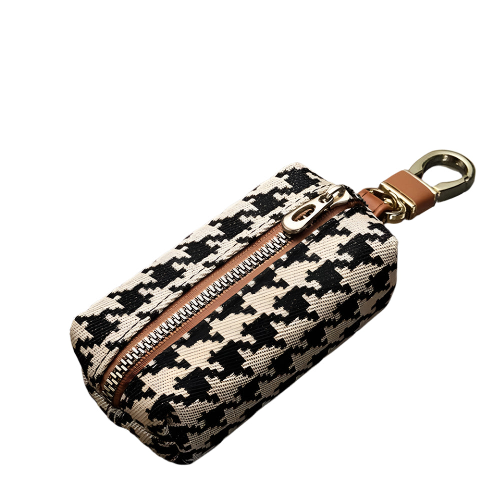 Houndstooth mini wallet keychain with full zipper and brown leather strap, black and white