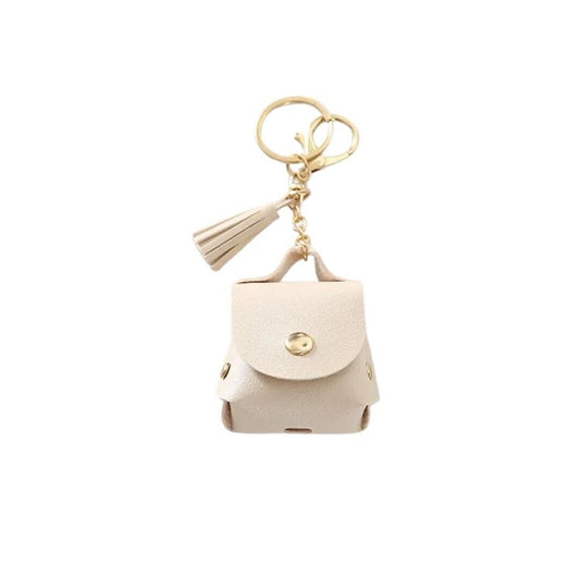 Beige faux leather earphone case with flap, keyring, and tassel charm