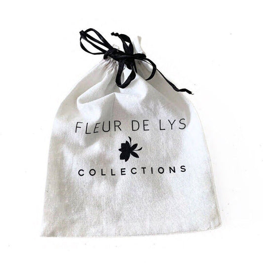 White drawstring pouch with black ribbon, printed text, and flower emblem
