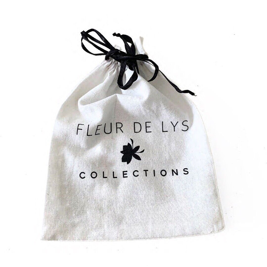 White pouch with black drawstring, FL PUR DE LYS COLLECTIONS text and flower logo