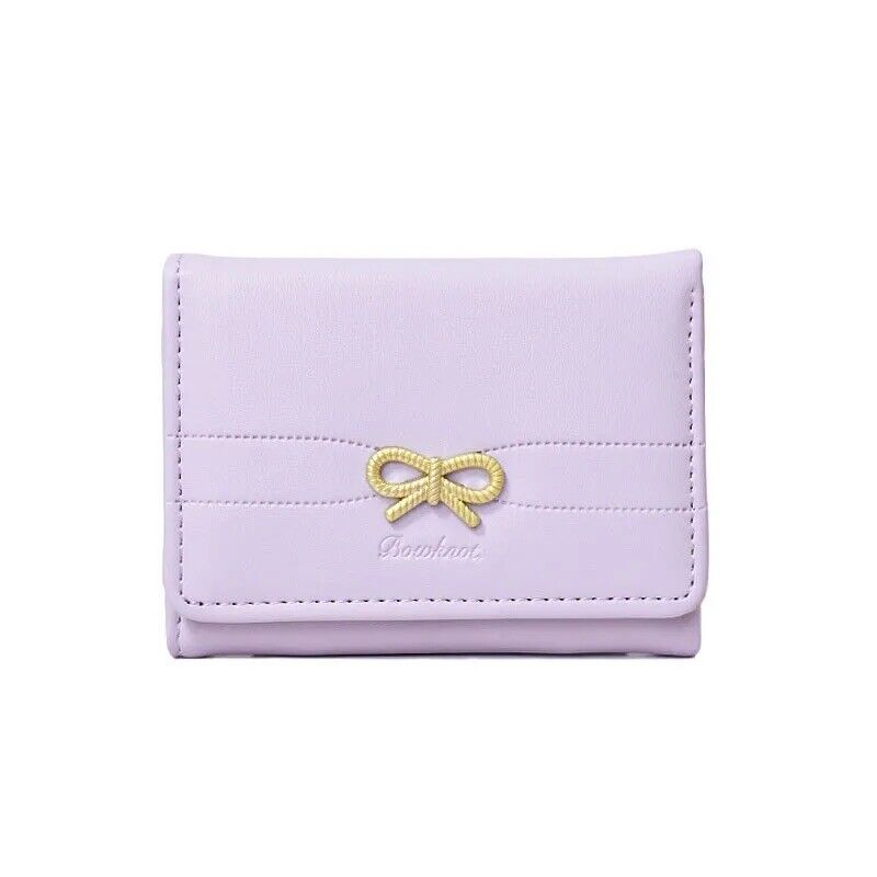 Lavender card holder wallet with gold bow emblem, stitched front
