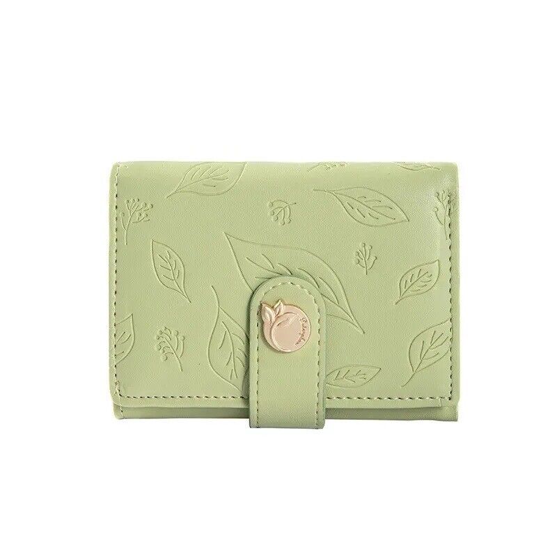 Pastel green mini card holder wallet with embossed leaf pattern and tab clasp