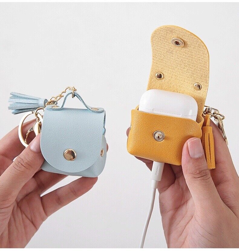 Tan and light blue earphone case protectors with keychains, tassels, and flap closures