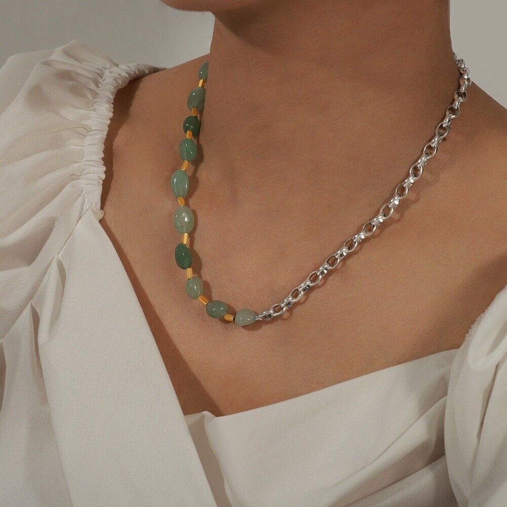 Green jade bead necklace with silver-tone chain on model neckline