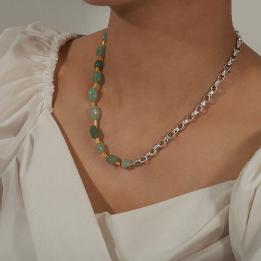 Green jade bead necklace with silver-tone chain on model neckline