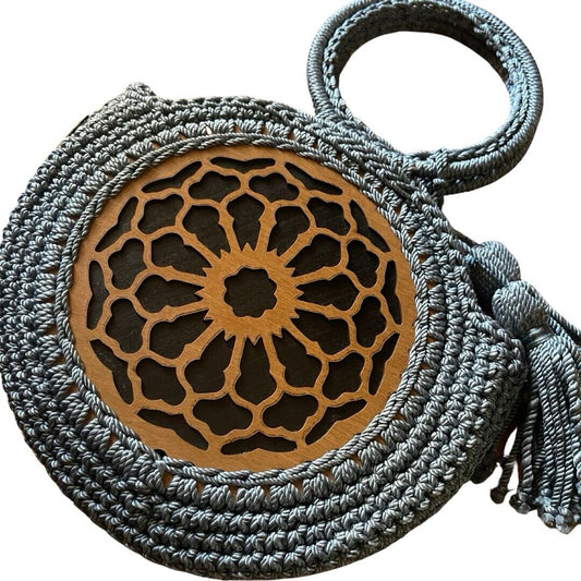Teal crochet bag with round wood-style medallion and tassel fringe