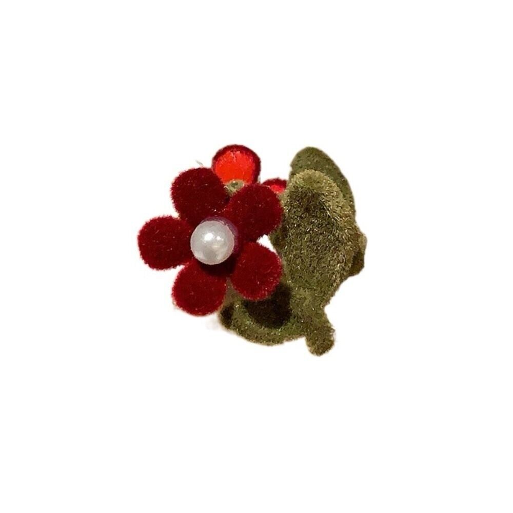 Velvet flower hair clip with red petals, white pearl center, and green backing