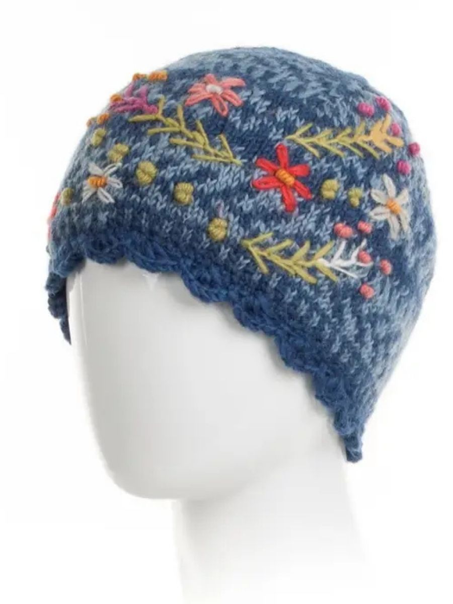 Navy blue wool knit beanie with colorful floral embroidery and blue ribbed cuff