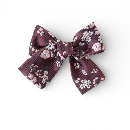 Petite hair bow in deep burgundy with small floral print and layered ribbon tails.