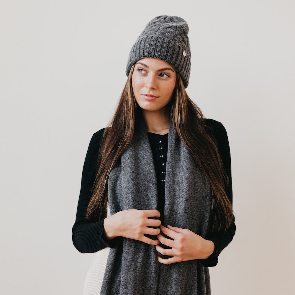 Charcoal cashmere beanie with satin lining, ribbed brim, and cable knit crown
