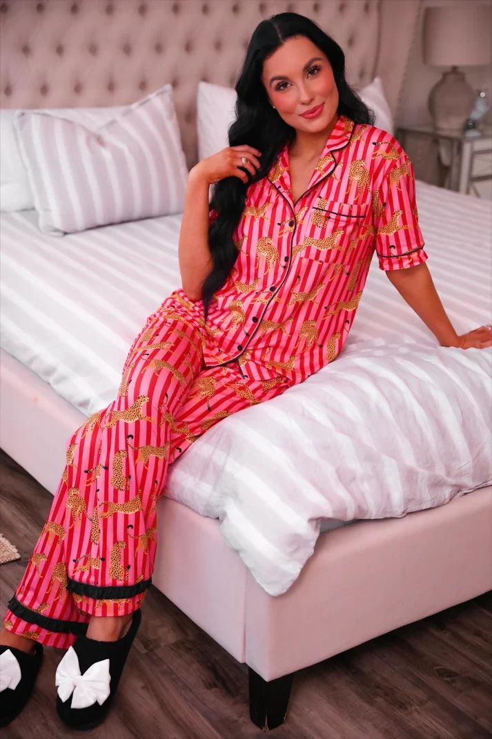 Pink ruffle pajama set with button-front shirt and matching striped leopard-print pants