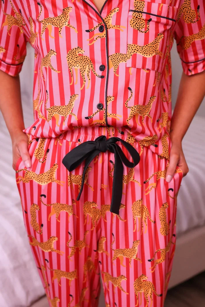 Pink leopard-print pajama set with button front and black bow tie waist detail