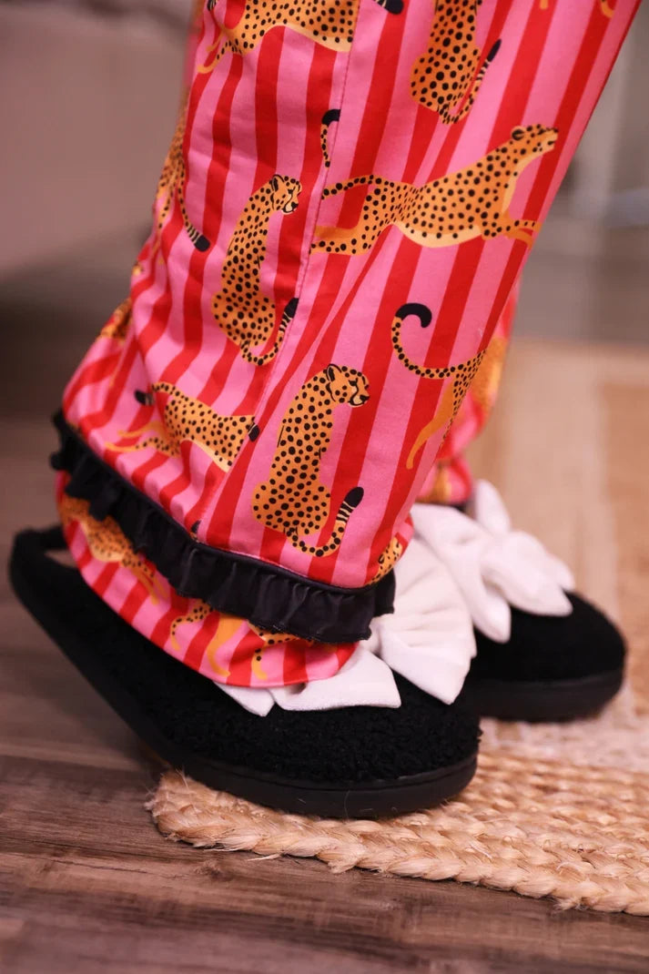 Pink pajama pants with leopard stripes and black-edged ruffled cuffs