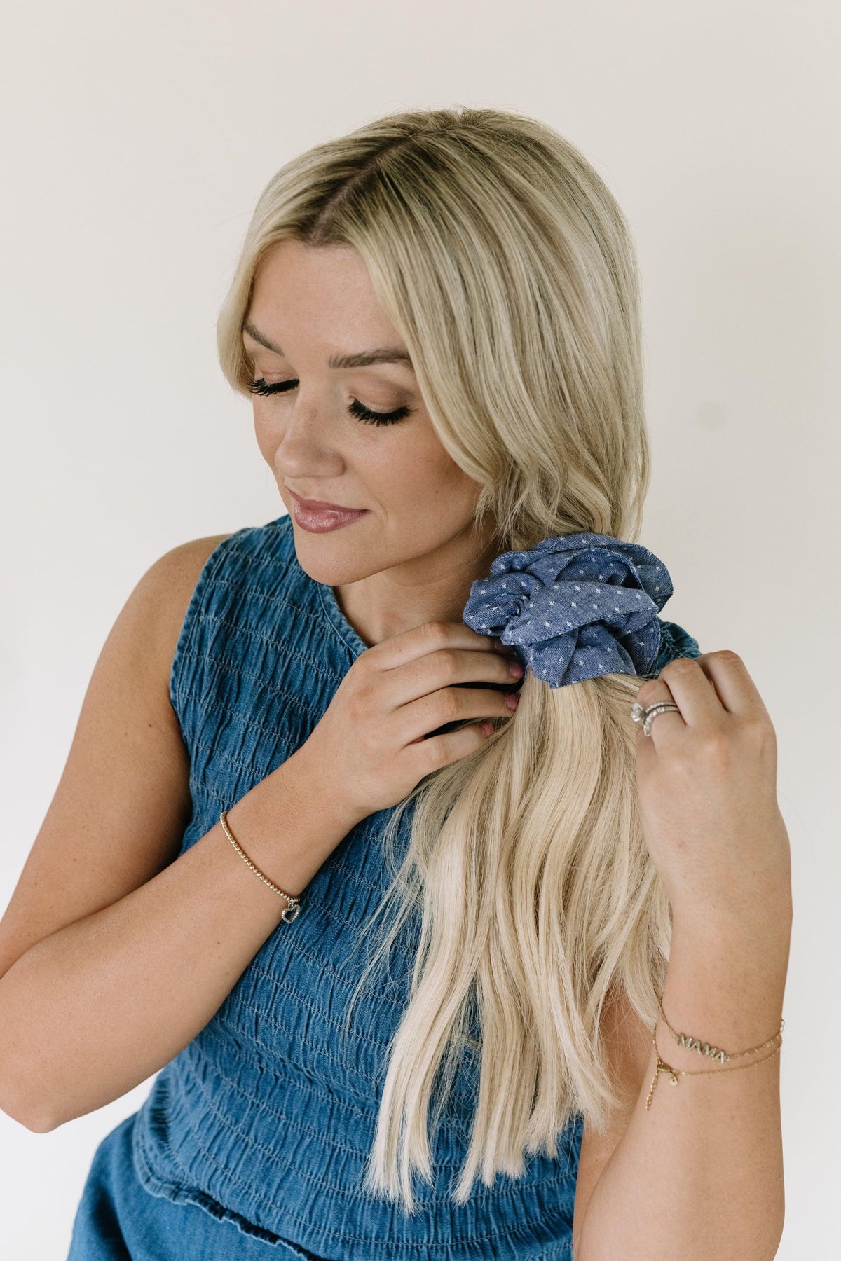 Blue patterned hair scrunchie securing blonde hair