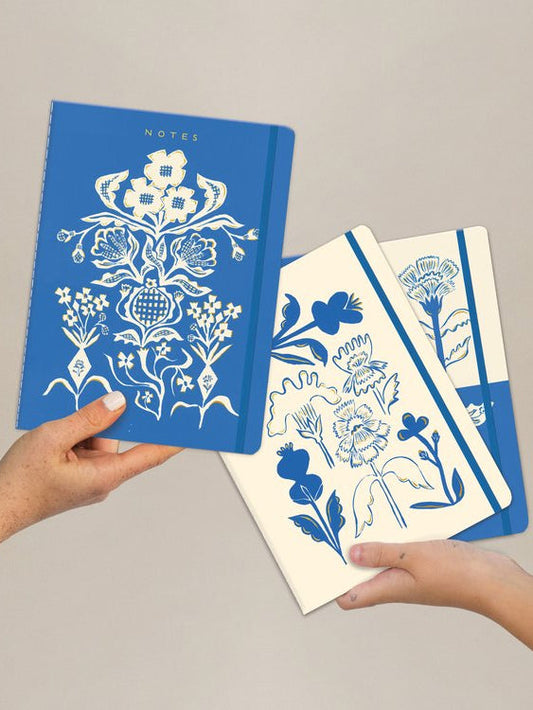 Blue floral notebook set of three, stitched covers, patterned pages visible