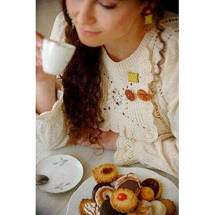 Orange flower and yellow dotted square cookie brooches on cream knit sweater