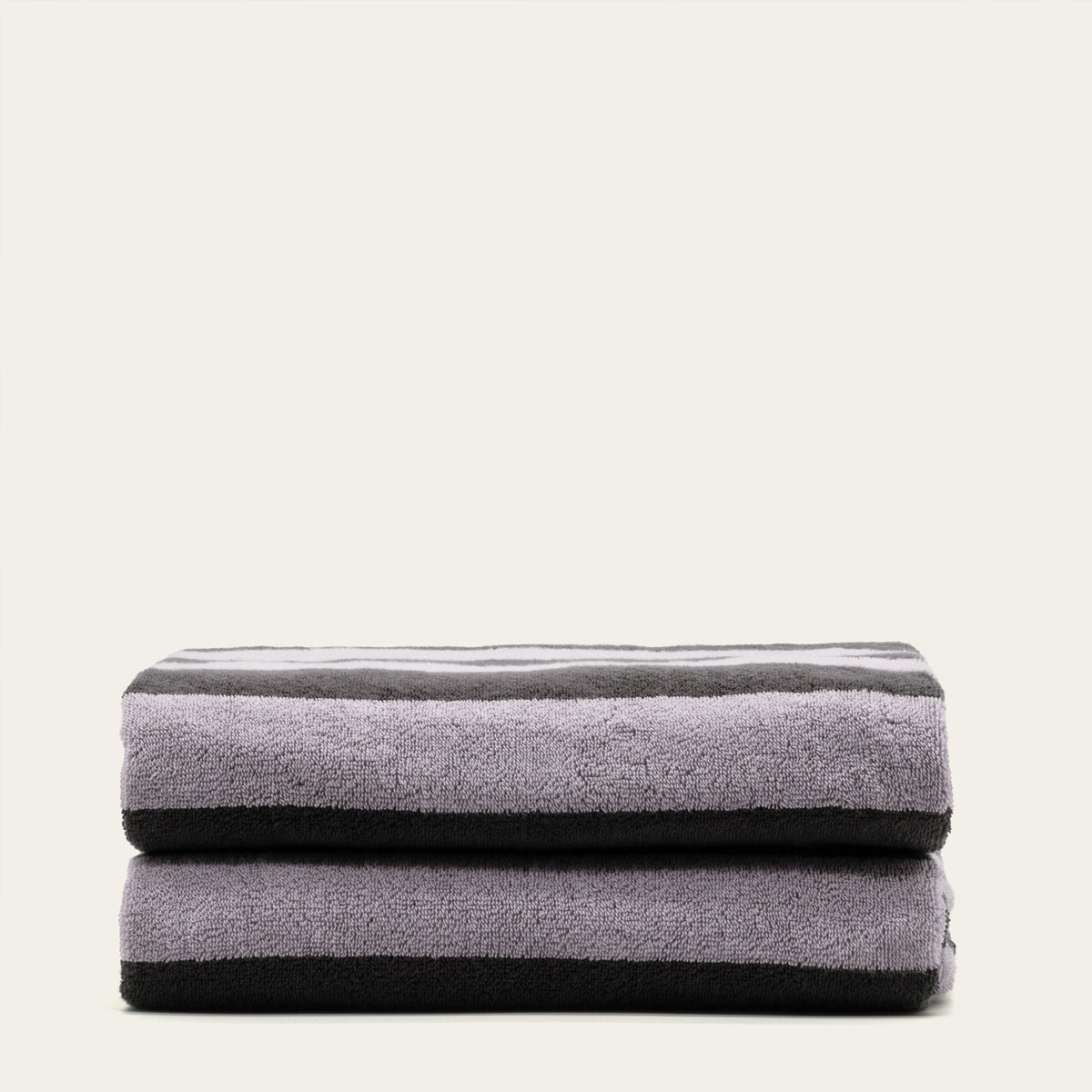 Light lilac bath towel folded into a neat stack