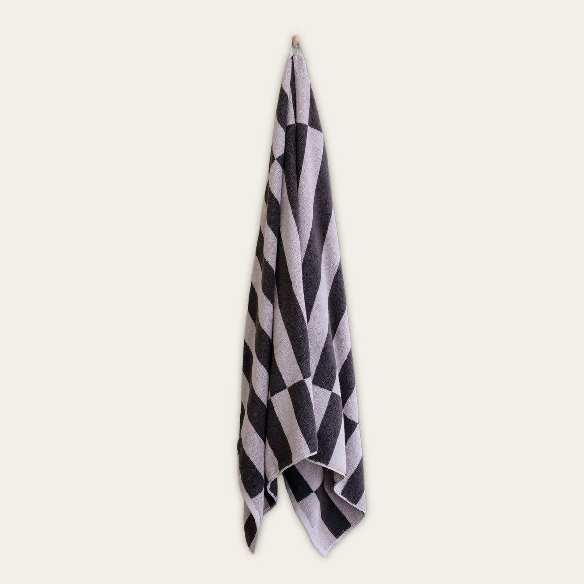 Single checkerboard towel with charcoal and lilac tones, neatly folded