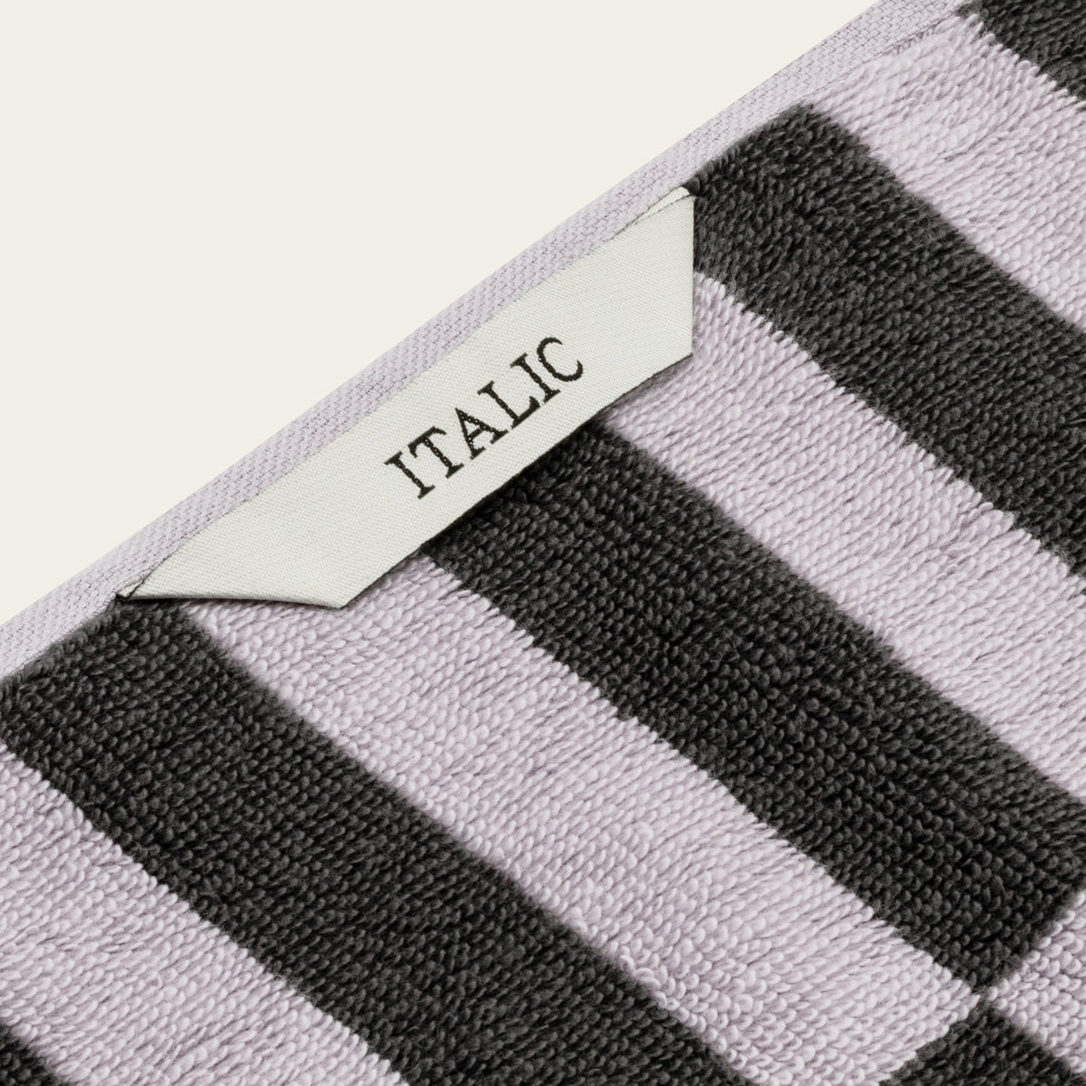 Cotton towel corner with woven tag reading “ITALIC” and black/white checks