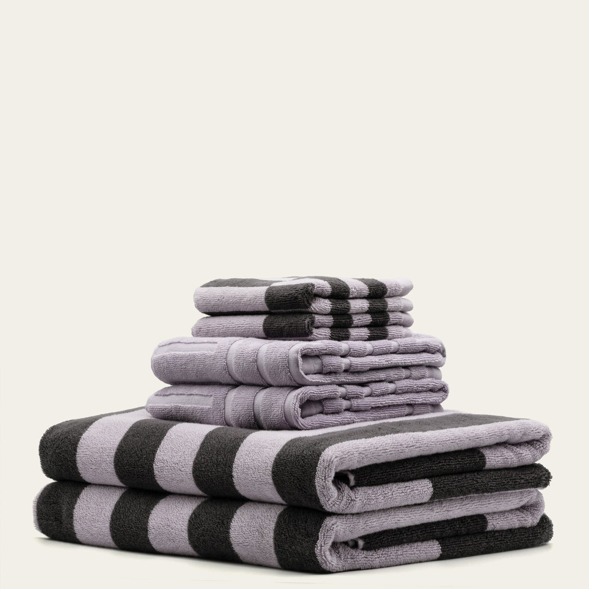 Stack of cotton towels with lilac-gray base and dark charcoal checks