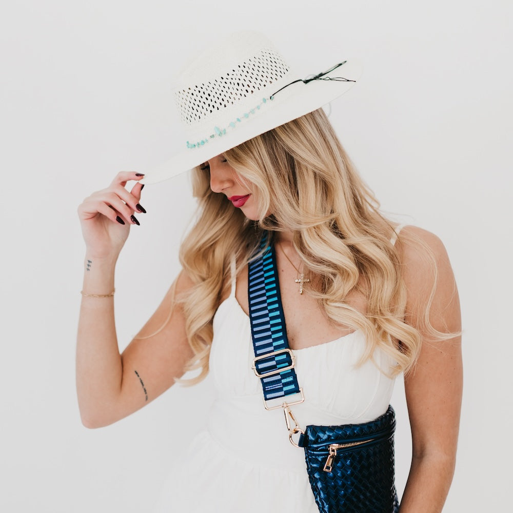 White western sun hat with perforated crown, turquoise beaded edge, and wide brim.