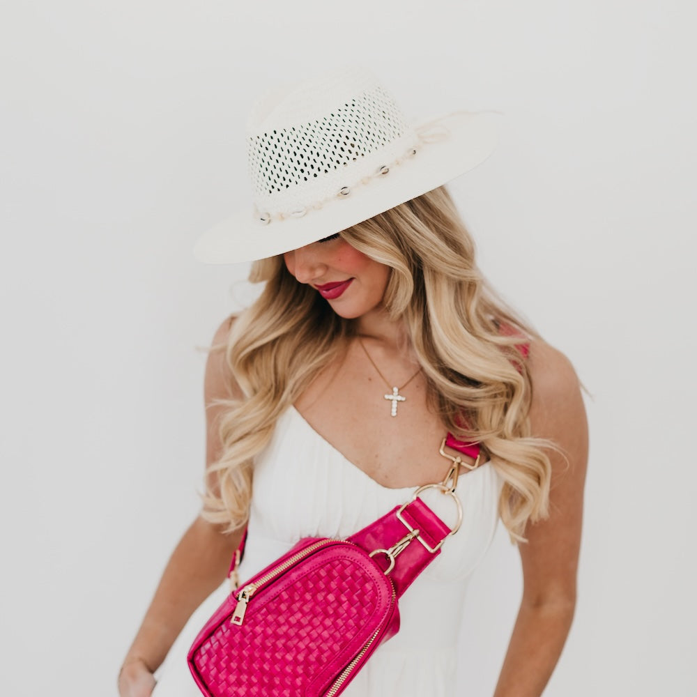 White woven western sun hat with perforated crown and wide brim, shell-style trim.