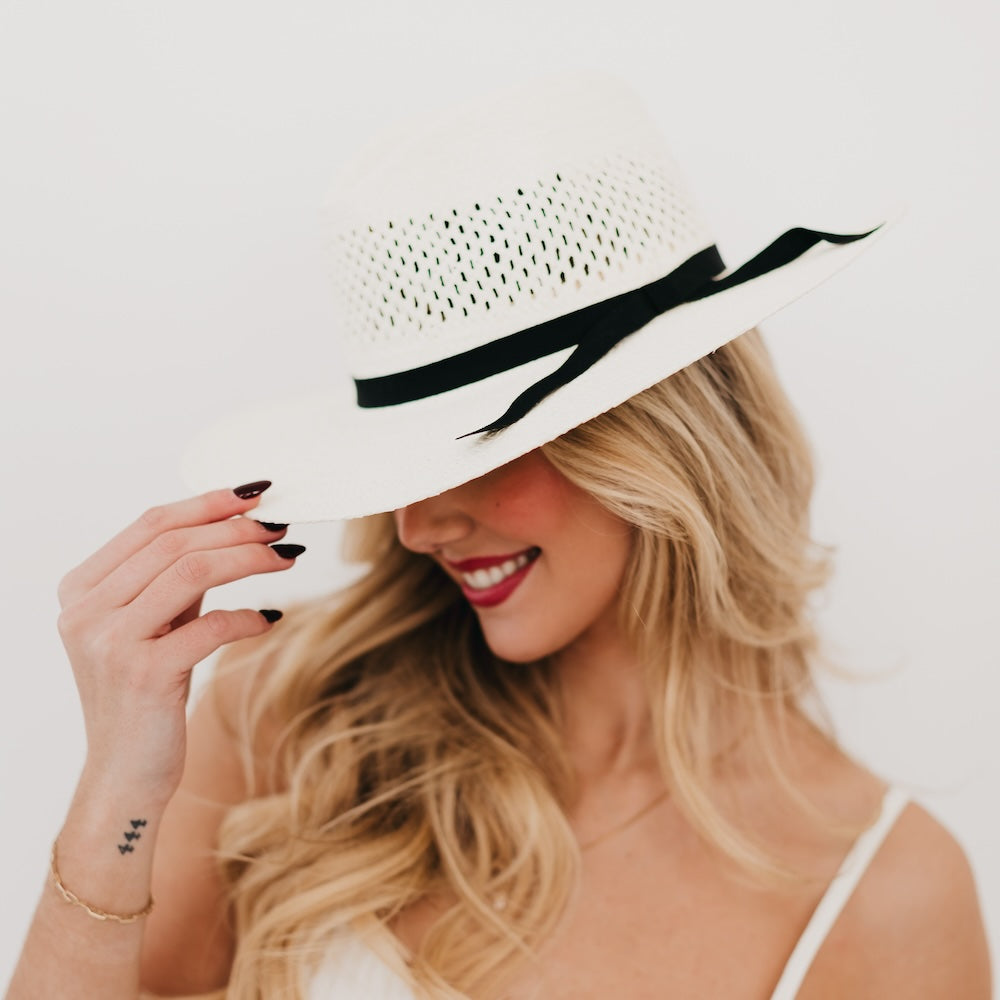 White western sun hat with perforated crown, black ribbon band, and wide brim.