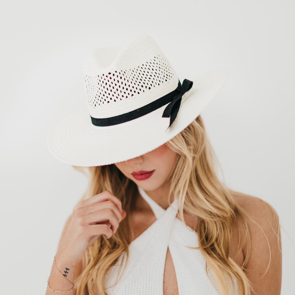 White western sun hat with perforated crown, black ribbon band, and wide brim.