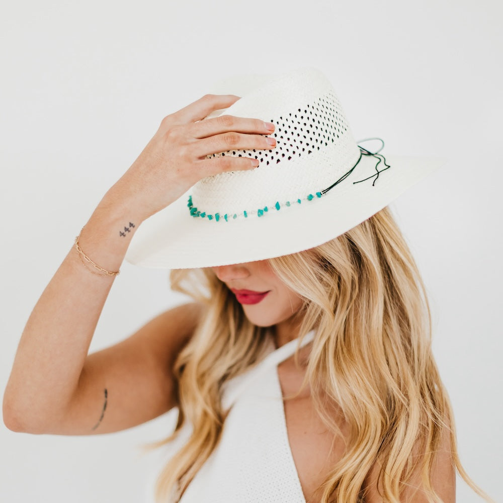 White western sun hat with perforated crown and turquoise beaded edge, wide brim.