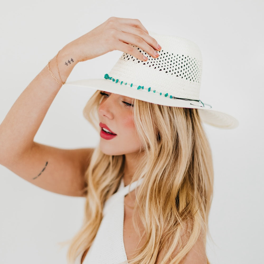 White perforated western sun hat with turquoise beaded trim, wide brim.