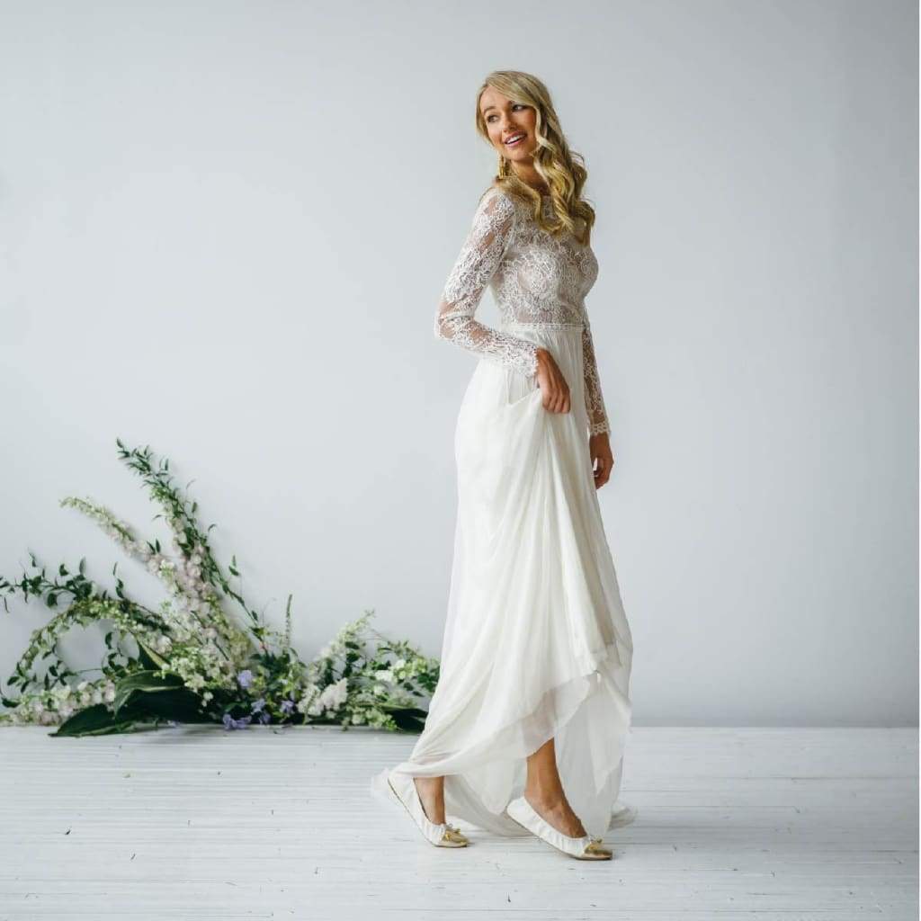 White metallic-toe flats worn with long skirt, bow detail and low sole