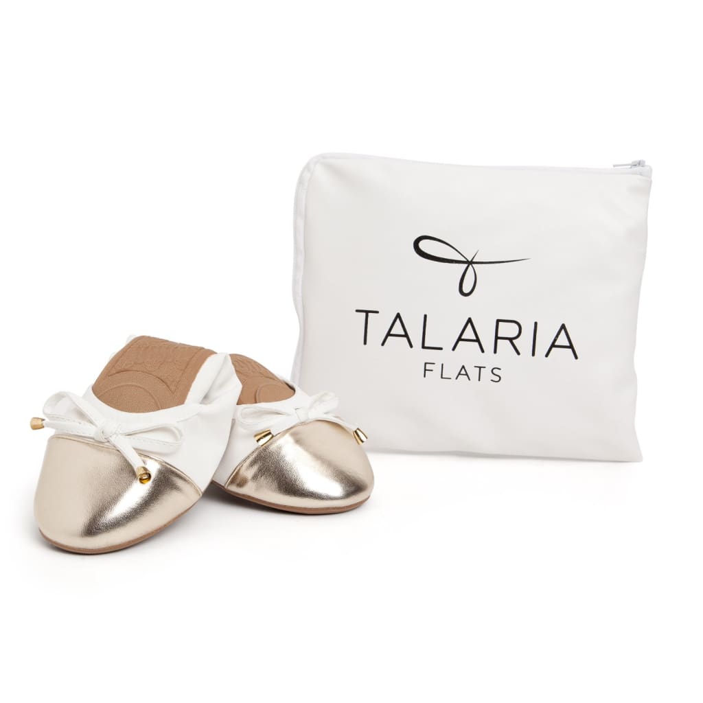 Pair of white flats with metallic toe caps and bow laces, with storage pouch