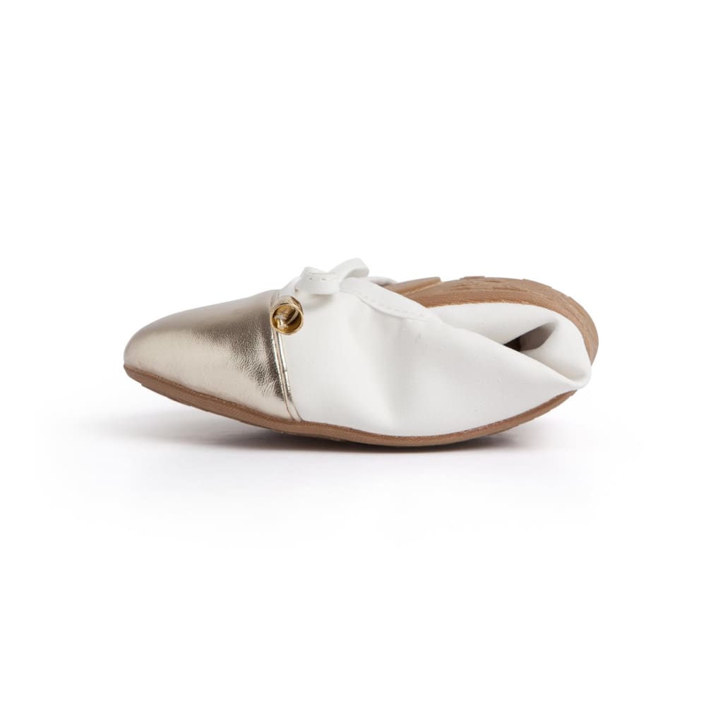 White flats with metallic toe, small bow at vamp and low profile sole